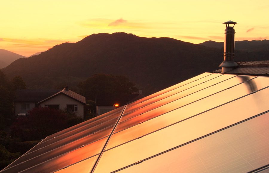 Panels on a house roof at sunset